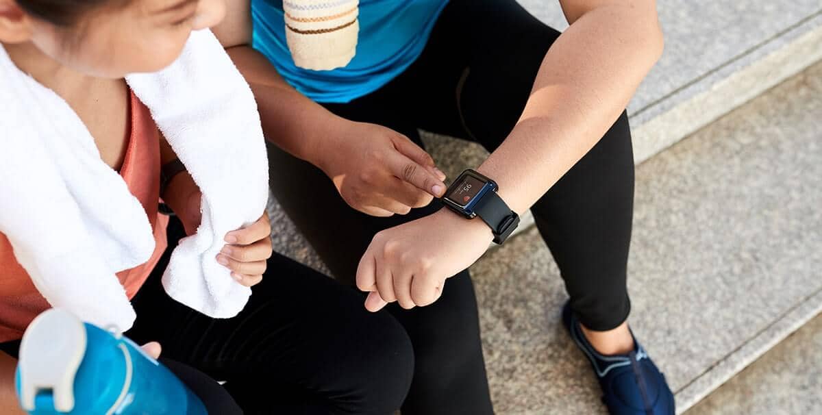 woman looking at her fitness tracker