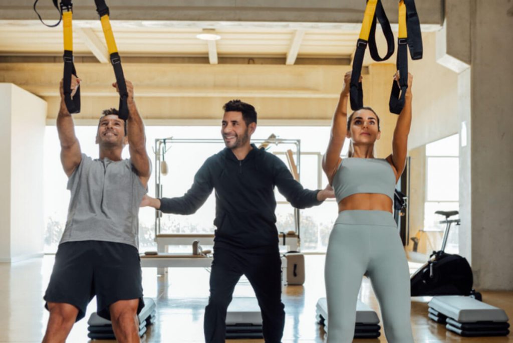 How TRX Works with two person demonstrating how to use the equipment
