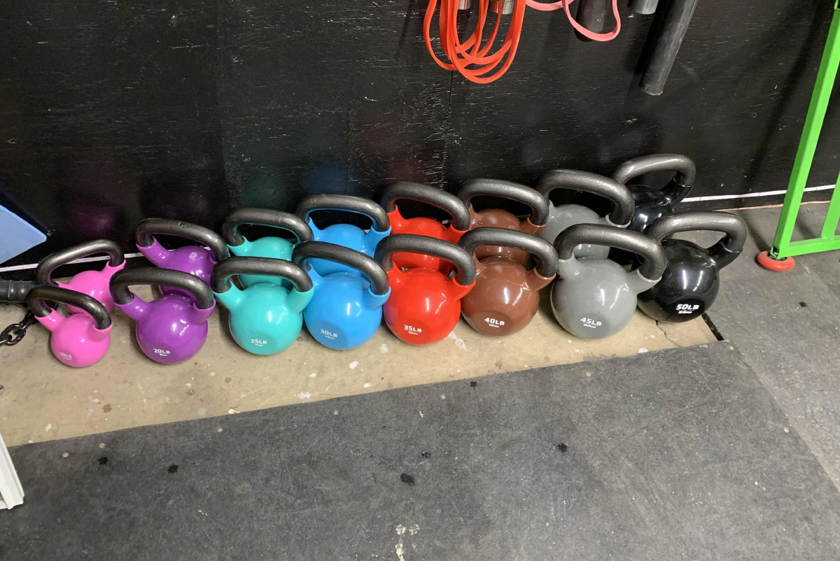 different colors of kettlebell on the floor