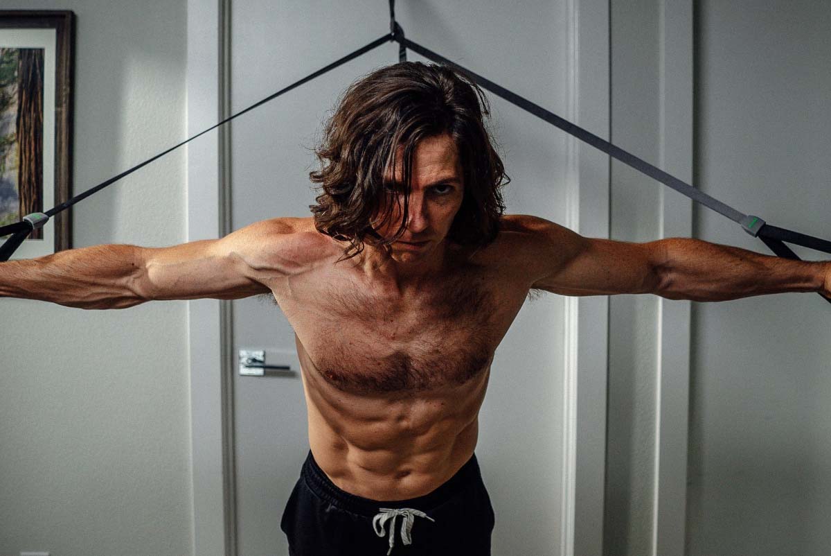 man working out in room with monkii bar attached to door